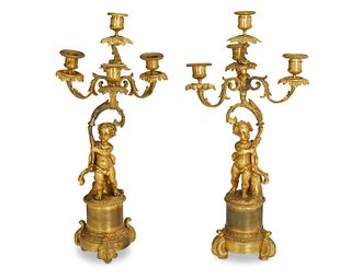 A pair of gilt-bronze figural candlesticks