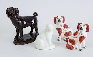 BROWN-GLAZED POTTERY FIGURE OF A HOUND, AN ASSEMBLED PAIR OF STAFFORDSHIRE SPANIELS AND A WHITE-GLAZED POTTERY PUG