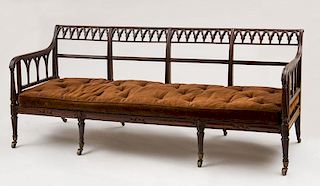 WILLIAM IV CARVED MAHOGANY AND CANED SETTEE, IN THE NEO-GOTHIC TASTE