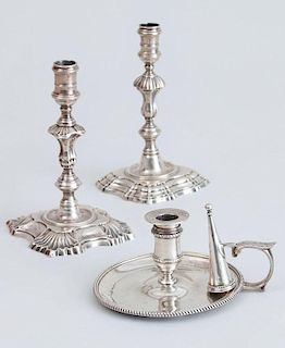 TWO SIMILAR GEORGE II CRESTED SILVER TAPER CANDLESTICKS AND A GEORGE III SILVER CHAMBER CANDLESTICK WITH ASSOCIATED FUNNEL SNUFFER