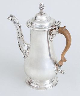GEORGE II CRESTED SILVER SMALL COFFEE POT AND A GEORGE III PEAR-FORM FOOTED COFFEE POT