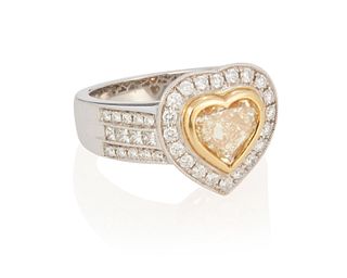 A yellow diamond and diamond ring