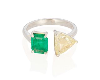 A fancy yellow diamond and emerald ring