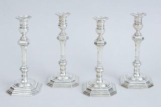 SET OF FOUR CRICHTON BROS. CRESTED AND WEIGHTED SILVER CANDLESTICKS IN THE QUEEN ANNE STYLE