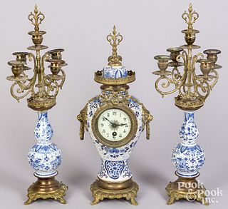 Delft brass mounted clock garniture.