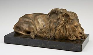 Gilt Bronze Sleeping Lion, 20th c., on a figured b