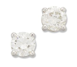 A PAIR OF SOLITAIRE DIAMOND EARRINGS