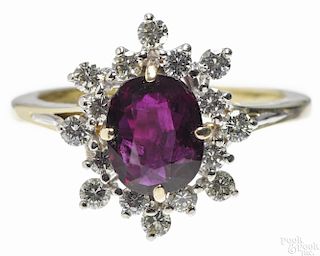 18K yellow gold, ruby, and diamond ring with an oval cut central ruby, approximately 2.25ct