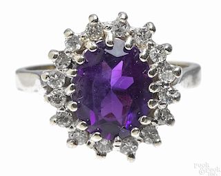 14K white gold, amethyst, and diamond ring with an oval cut central amethyst