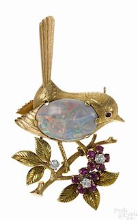 18K yellow gold, diamond, ruby, and opal bird pin with an oval opal cabochon body