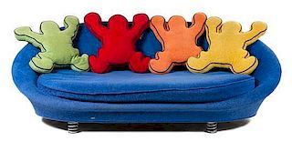 * A Keith Haring Sofa, by Bretz, CIRCA 1998, blue oval sofa with four iconic Keith Haring figural cushions in various colors
