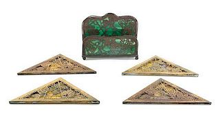 Tiffany Studios, a set of four blotter corners, together with a letter rack