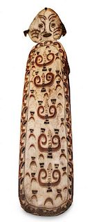 * A Carved Wooden Ceremonial War Shield, Papua, New Guinea Height 86 inches
