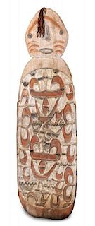 * A Carved Wooden Ceremonial War Shield, Papua, New Guinea Height 65 inches
