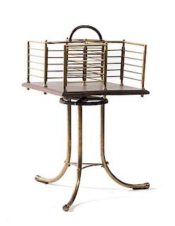 An Art Nouveau Wood and Brass Magazine Rack, EARLY 20TH CENTURY, the square top raised on a tripod base