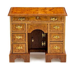 A George III Style Burlwood Kneehole Desk Height 2 1/2 x width 2 7/8 x depth 1 5/8 inches.