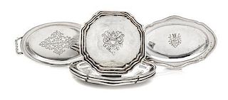 A Group of Six Silver Platters, , comprising a set of four examples of oval form with engraved decoration, together with a tw