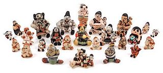 A Group of Twenty-Six Pottery Figures Height of tallest 1 3/4 inches.