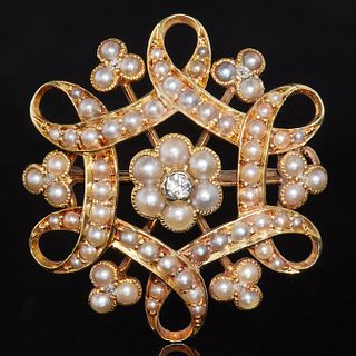VICTORIAN PEARL AND DIAMOND BROOCH. set with diamonds and pearls , in an open work floral design. 2.7 cm diameter. 5.9 grams.