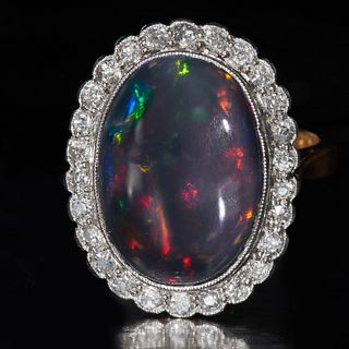 LARGE OPAL AND DIAMOND CLUSTER RING, Set with a large opal of approx. 6.92 ct. Surrounded with diamonds totalling approx. 0.52 ct. L. head 20.5 mm. Si