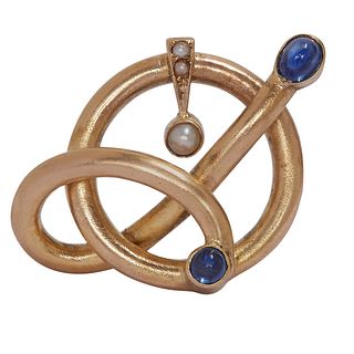 VICTORIAN SAPPHIRE AND PEARL BROOCH, of part entwined design. Set with 2 cabochon cut blue sapphires, flanked with pearls. Diam. 3 cm. 4.4 grams.