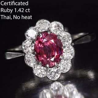 CERTIFICATED 1.42 CT. RUBY AND DIAMOND CLUSTER RING, in 18 ct. gold. Set with a central oval cut ruby of 1.42 ct. Surrounded with daimonds. Size L 1/2
