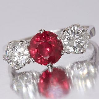 IMPRESSIVE RUBY AND DIAMOND THREE STONE RING. set with a large ruby in the centre approx 1.64 ct. flanked by two large diamonds totalling approx 1.05 