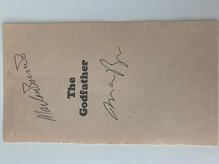 Mario Puzo and Marlon Brando The Godfather signed book page. GFA Authenticated