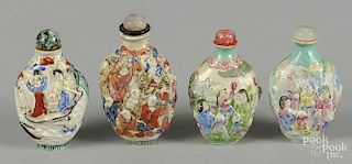 Four Chinese molded porcelain snuff bottles, with figural decoration.