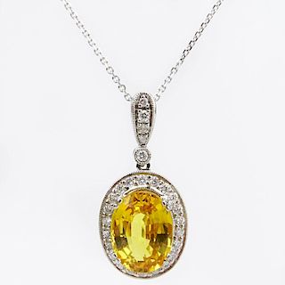 Approx. 6.50 Carat Oval Cut Yellow Sapphire, .63 Carat Diamond and 18 Karat White Gold Pendant with 14 Karat White Gold Chain
