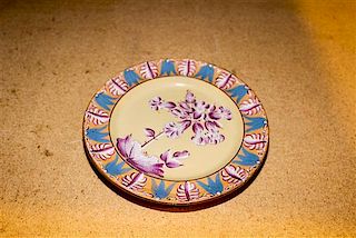 * A Polychrome Decorated Stoneware Plate Diameter of larger 8 1/4 inches.