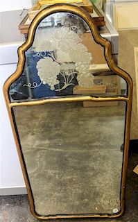 A Gilt and Ebonized Mirror. Length 38 inches.