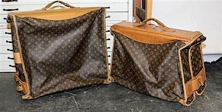 * Two Louis Vuitton Monogram Canvas Garment Bags. Height of first 43 inches.