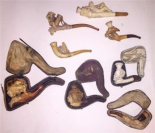 A Collection of Figural Meershaum and Wood Pipes Length of longest 6 inches.
