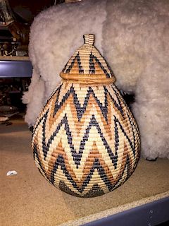 An African Woven Basket Height 13 1/2 inches.