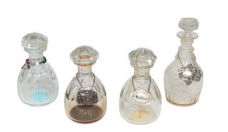 Group of Four Crystal Decanters, 20th c., consisting of three matching Baccarat examples and a taller example, two with silverplated labels for "Brand