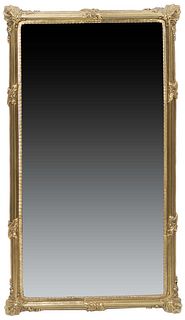 French Louis XVI Style Brass Overmantel Mirror, 20th c., with a reeded rounded frame with relief leaf decoration and corners, H.- 36 1/2 in., W.- 20 1