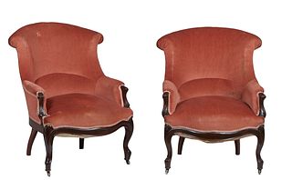 Pair of French Carved Walnut Louis XV Style Armchairs, c. 1870, the curved rolled canted back over upholstered arms and a bowed seat, on cabriole legs
