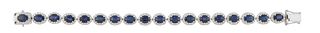 14K White Gold Link Bracelet, each of the eighteen oval links with a graduated oval sapphire, atop a border of tiny round diamonds, total sapphire wt.