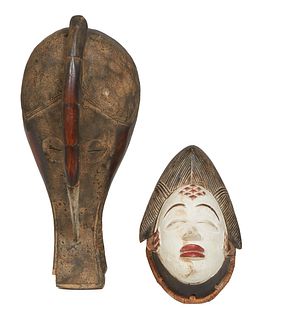 Two African Carved Wood Masks, 20th c., one a polychromed example and one a long example, H.- 18 3/4 in., W.- 7 1/2 in., D.- 6 1/2 in. (2 Pcs.)