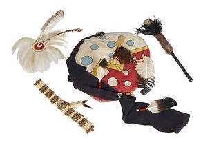 Four Pieces of Native American Ceremonial Decoration, 20th c., consisting of a feather decorated hide shield, a feathered beaded headband, a brass and