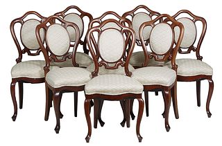 Group of Eight Chairs consisting of a Set of Eight English Carved Mahogany Dining Chairs, 20th c., the canted arched pierced backs with central oval c