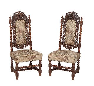 Pair of French Carved Oak Louis XIII Style Side Chairs, c. 1880, with a love bird carved crest over a canted cushioned back flanked by pierced scroll 
