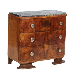 French Art Deco Carved Walnut Marble Top Commode, c. 1940, the rounded corner highly figured black marble over a band of three convex deep drawers, on