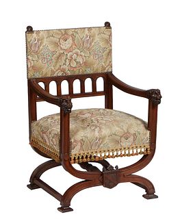 French Renaissance Style Carved Oak Savonarola Style Fauteuil, 19th c., the rectangular back with floral carved finials above an upholstered back atop