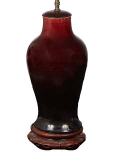 Oriental Oxblood Porcelain Baluster Vase, 19th c., now with a wooden cap and circular base, wired as a lamp, H.- 16 1/2 in., Dia.- 7 in. Provenance: T