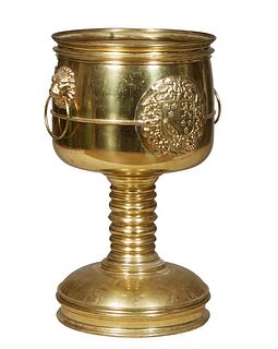 Large Brass Cylindrical Planter, 20th c., the circular top with two lions head ring handles, on a ring turned base to a sloping circular base, H.- 34 