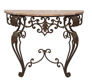 French Wrought Iron Marble Top Console Table, 20th c., the bowed highly figured tan marble on a scrolled skirt, on cabriole leaf mounted scrolled legs