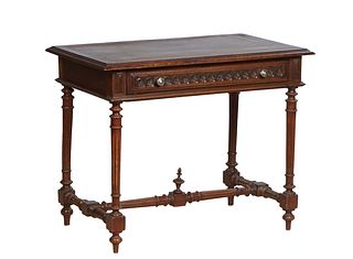 French Provincial Henri II Style Carved Oak Writing Table, late 19th c., the stepped rounded edge rectangular top over a frieze drawer over a wide ski