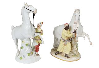 Pair of Meissen Figural Groups, early 20th c., each of a rearing horse on a tree stump support being lead by a man, marked with under glaze blue cross